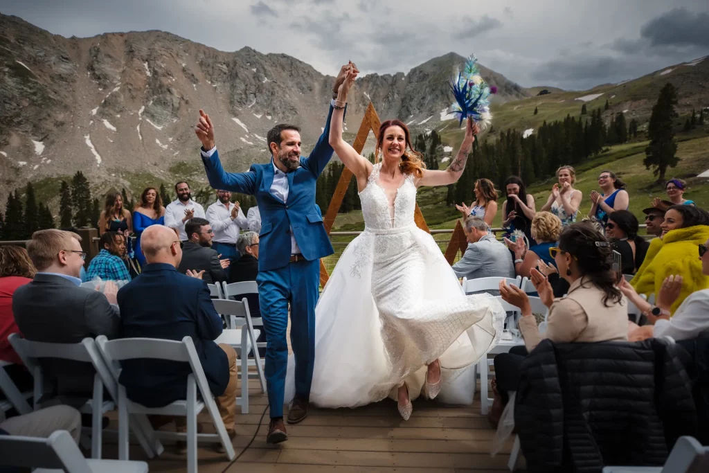 A bride and groom celebrate during their recessional at their Arapaho Basin Wedding.
