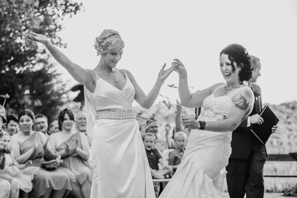 Two brides celebrate after being pronounced wives.