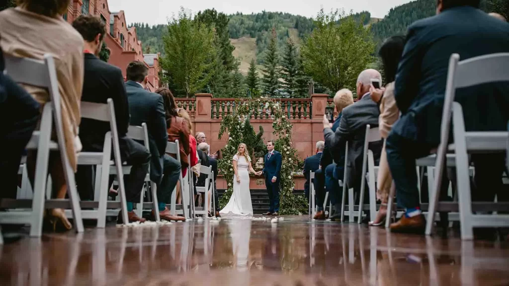 Bride and Groom look out at their guests during their St. Regis, Aspen, CO wedding.