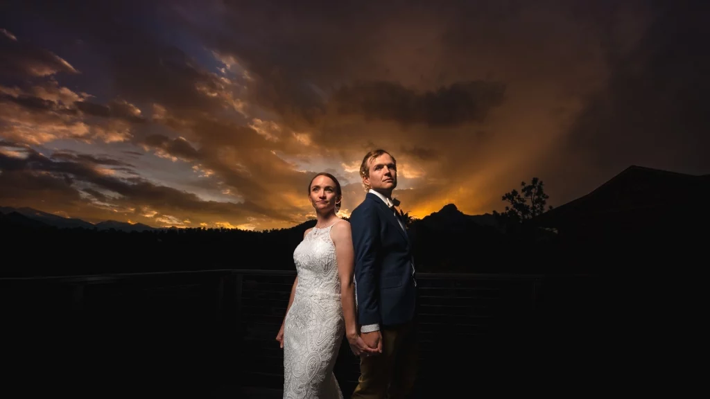 Bride and Groom stand together at sunset in an editorial style in Estes Park, CO