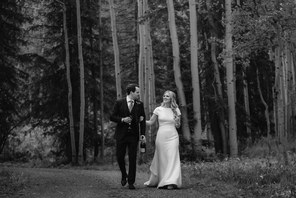Bride and groom walking through an aspen grove in Aspen, CO.