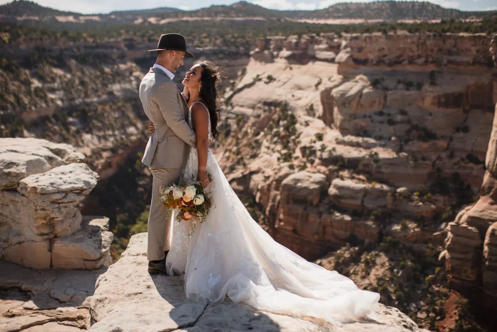 A bride and groom hugging on the Colorado Monument in Grand Junction, CO.