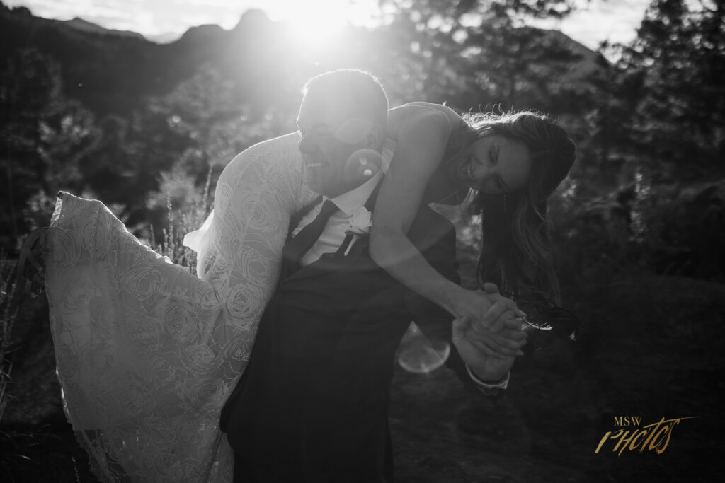 Groom carring the bride over his shoulder at the Black Canyon Inn