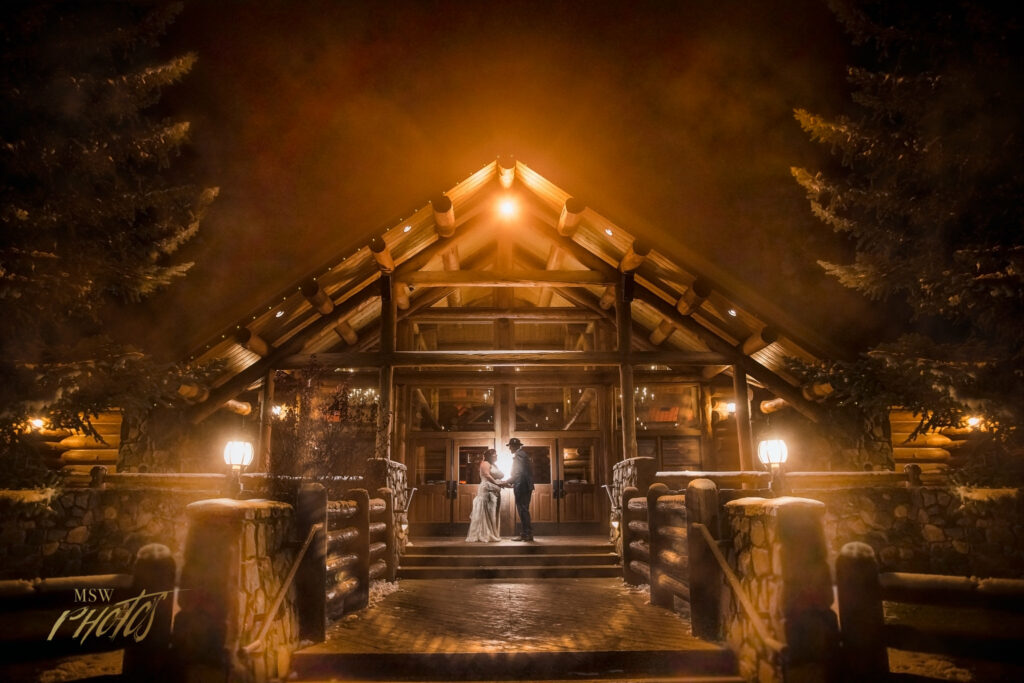 Portrait of a wedding couple in the fog at their Evergreen, CO wedding venue.
