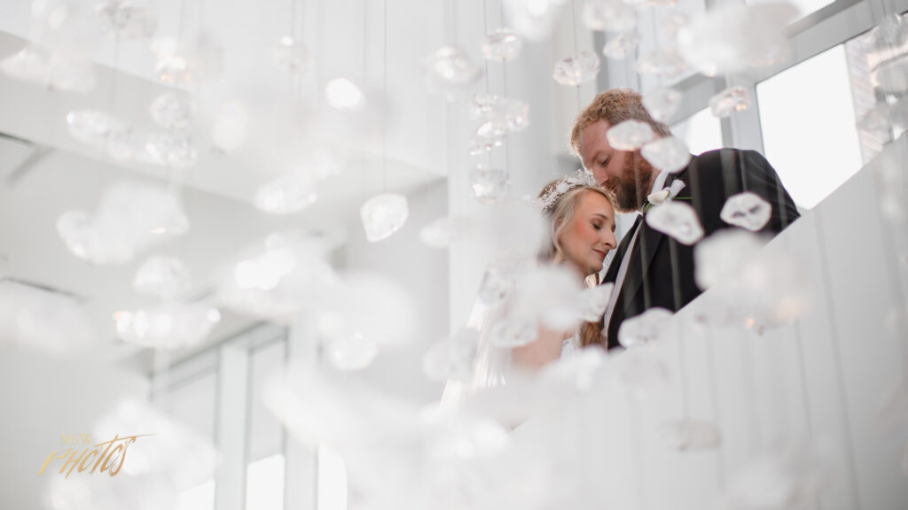 Denver wedding couple embracing in front of a chandelier.