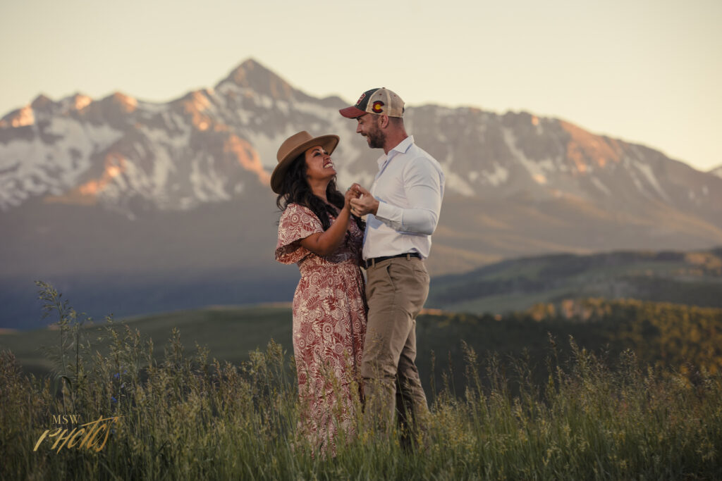 Engaged couple dances in an alpine meadow in Telluride, CO.