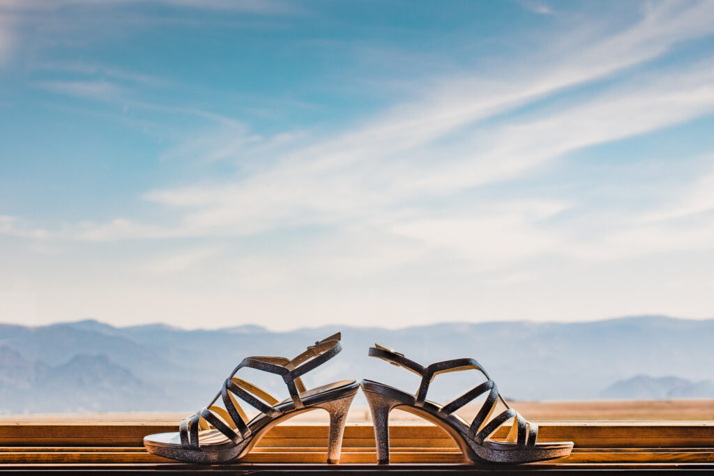 Wedding shoes in front of a Colorado landscape.