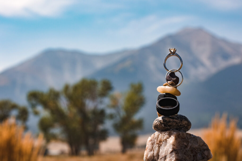 Wedding rings in front of a Buena Vista, CO landscape.